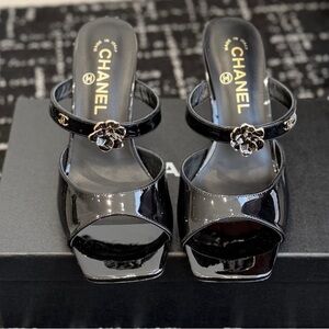 CHANEL Glossy Black Heels with Floral Embellishment